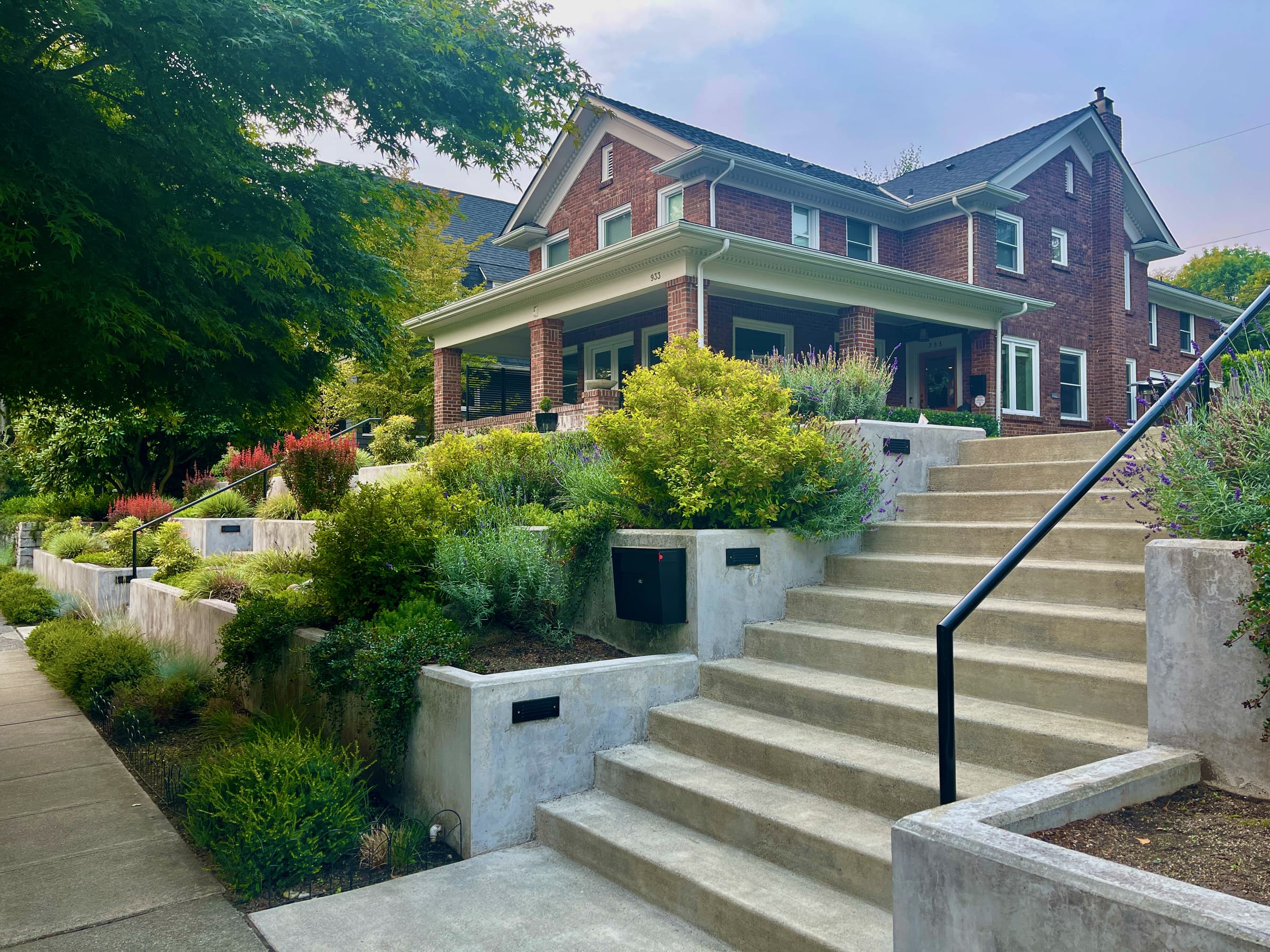 A brick Seattle home above terraced gardens and concrete steps