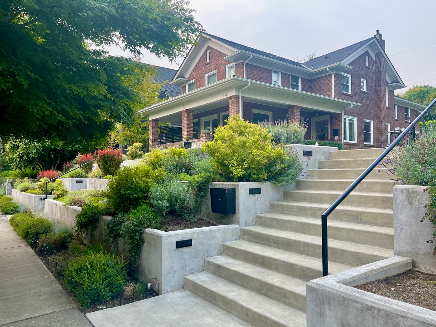 A brick home on a tree-lined Capitol Hill street