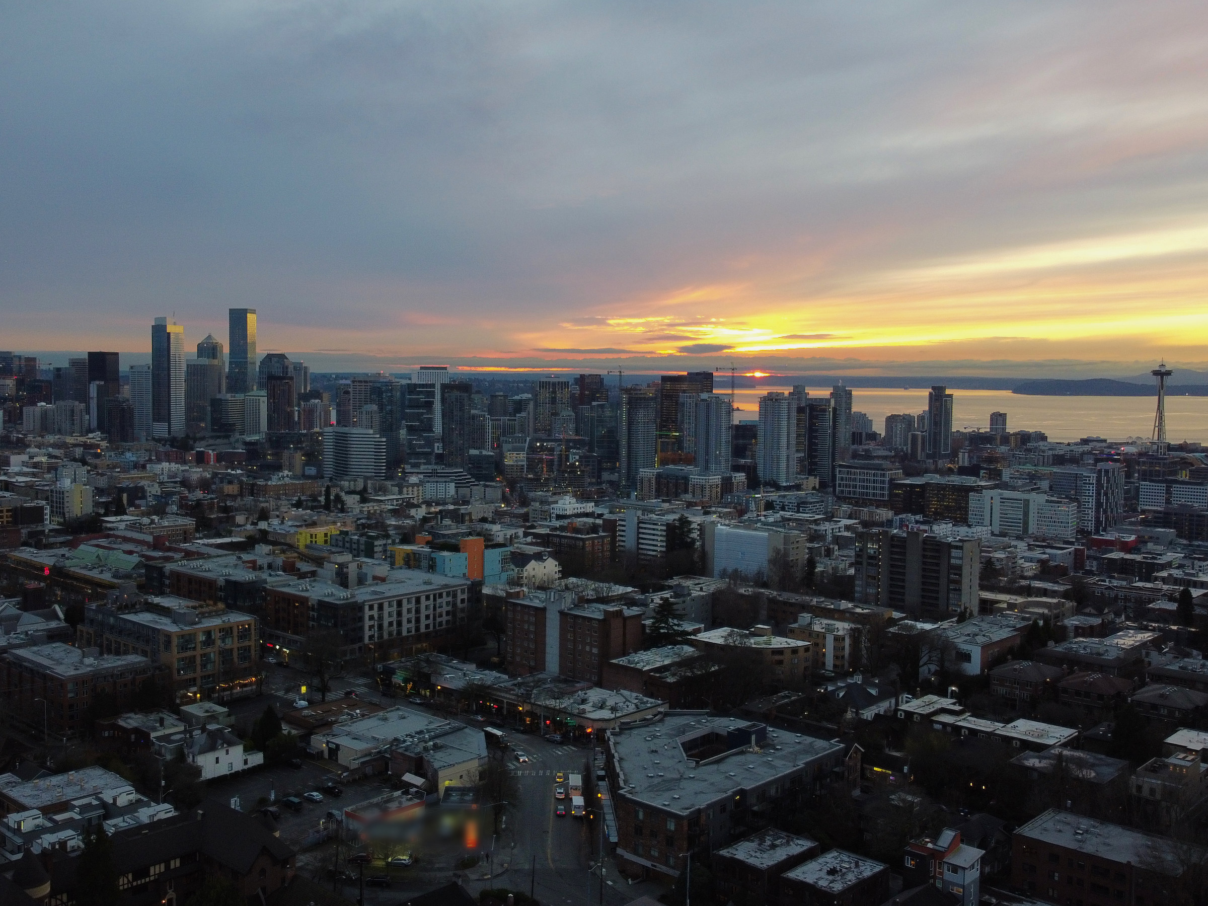 The Seattle skyline and Space Needle at sunset, seen from the air